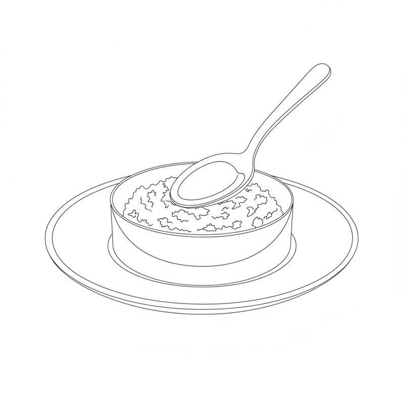 Un aro redondo sobre un plato se rellena con tartar y se presiona con una cuchara